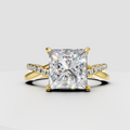 Princess cut diamond crossover pavé engagement ring in polished yellow gold