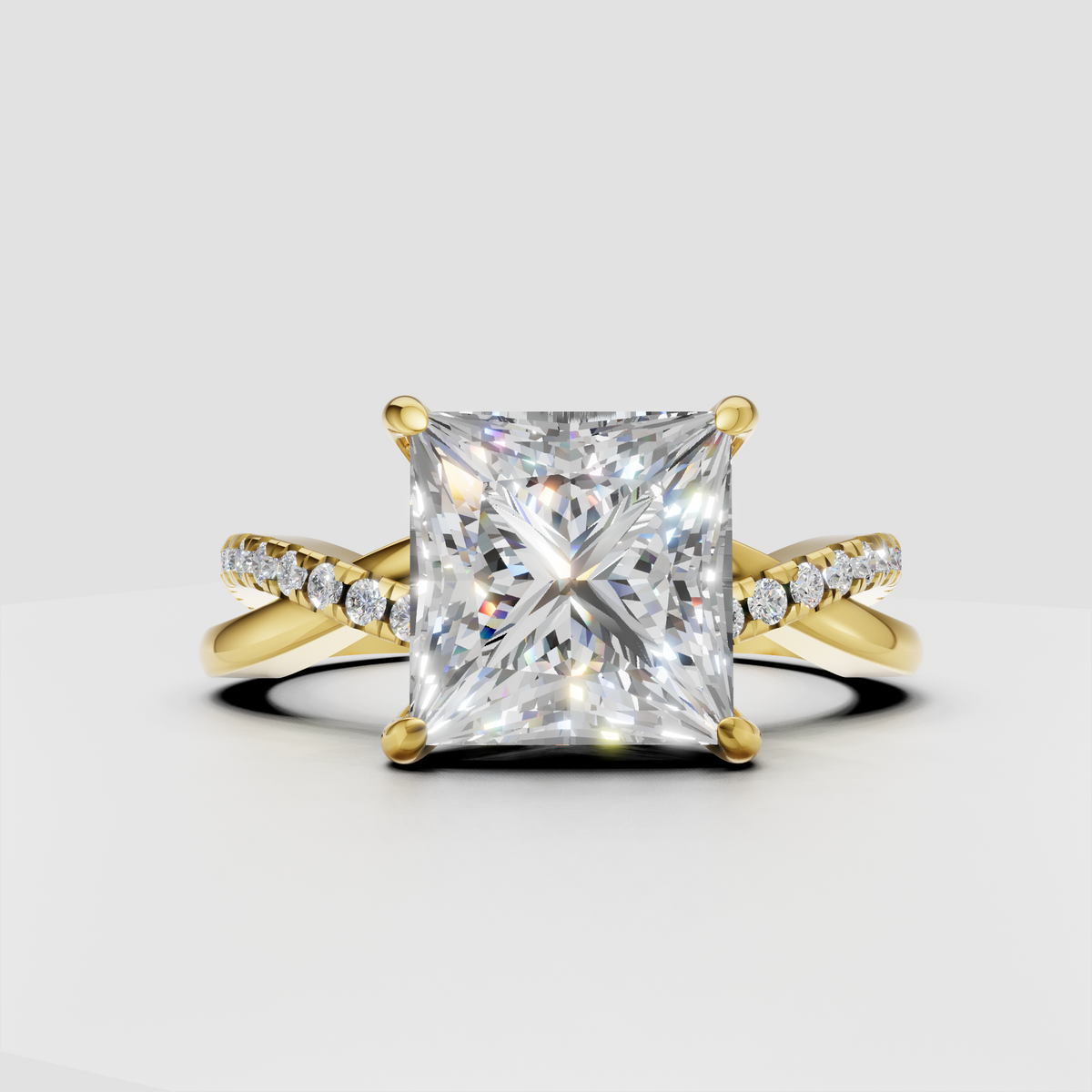 Princess cut diamond crossover pavé engagement ring in polished yellow gold
