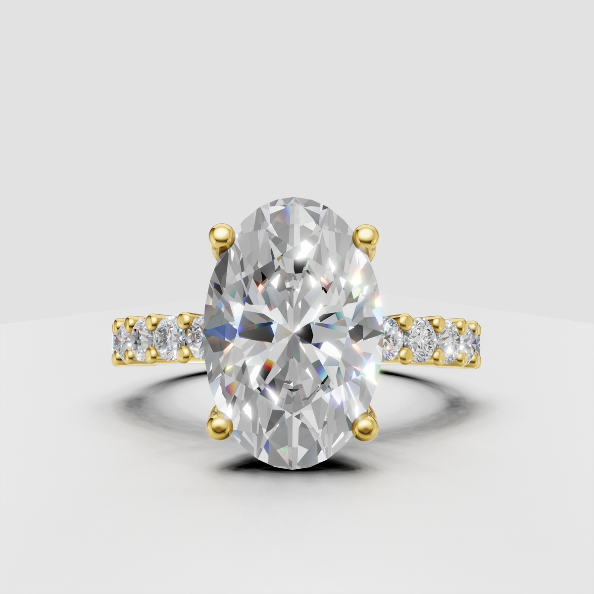 Oval diamond four-prong yellow gold engagement ring with baguette side stones
