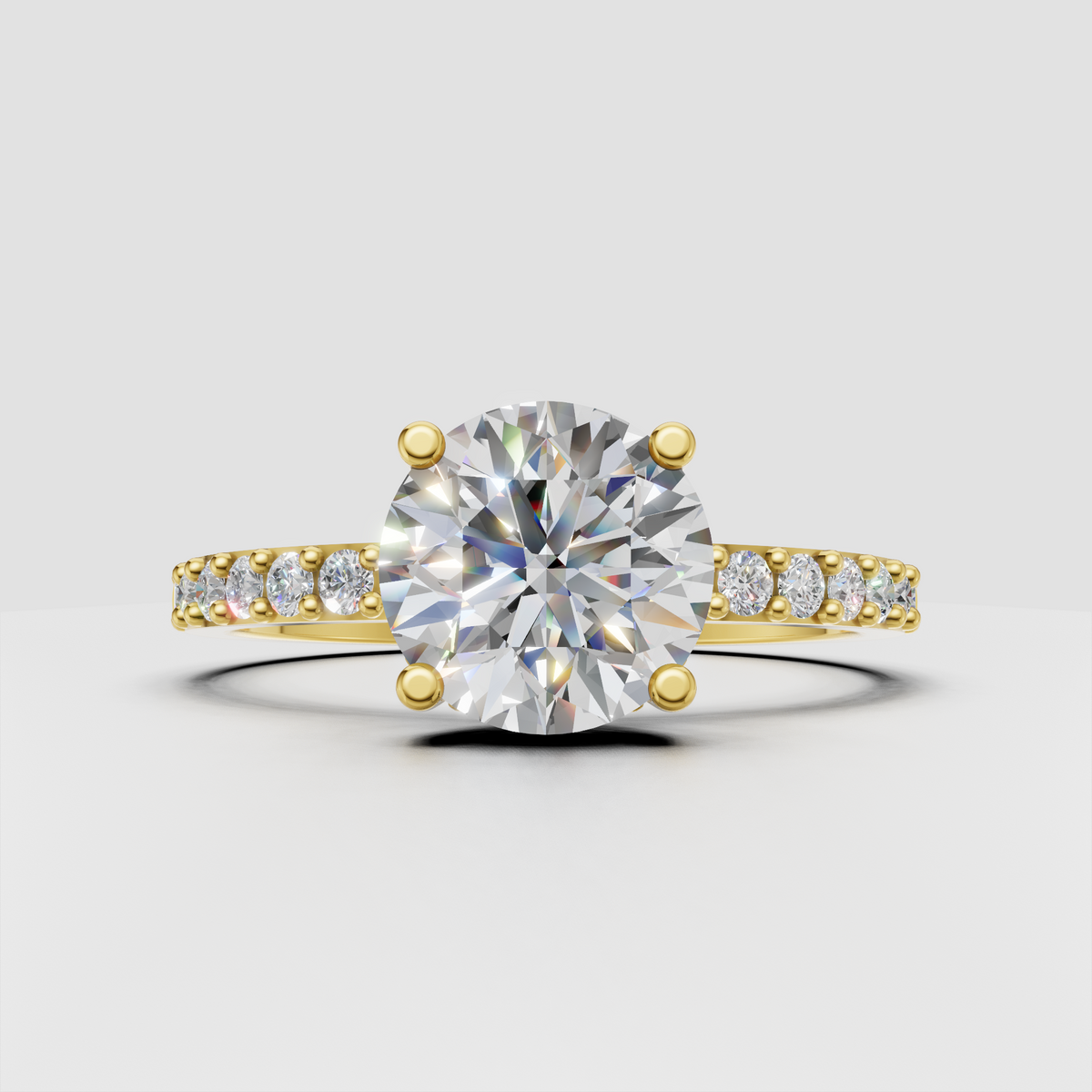 Round diamond four-prong cathedral engagement ring in polished yellow gold