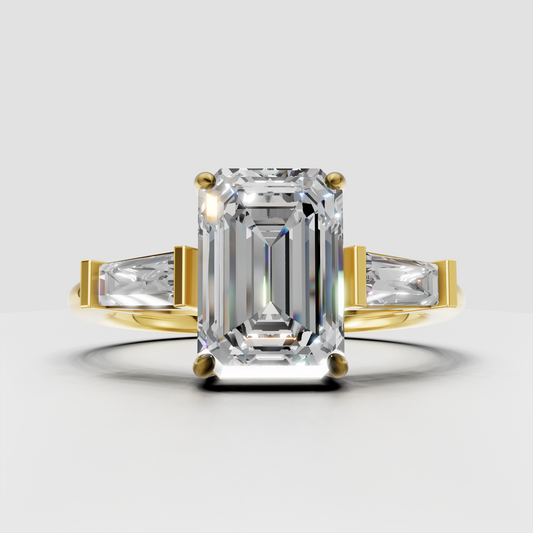 Emerald cut diamond three stone engagement ring with baguette side stones in yellow gold