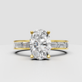 Oval diamond four-prong yellow gold engagement ring with baguette side stones