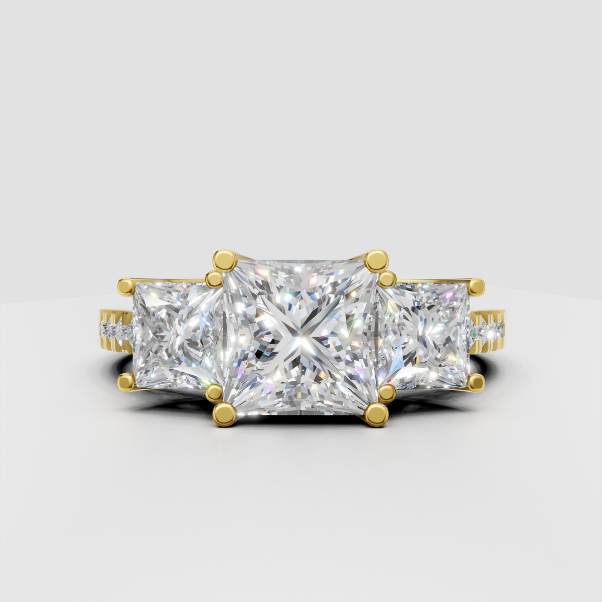 Princess cut three stone diamond engagement ring in yellow gold