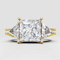 Princess cut diamond three stone engagement ring in polished yellow gold