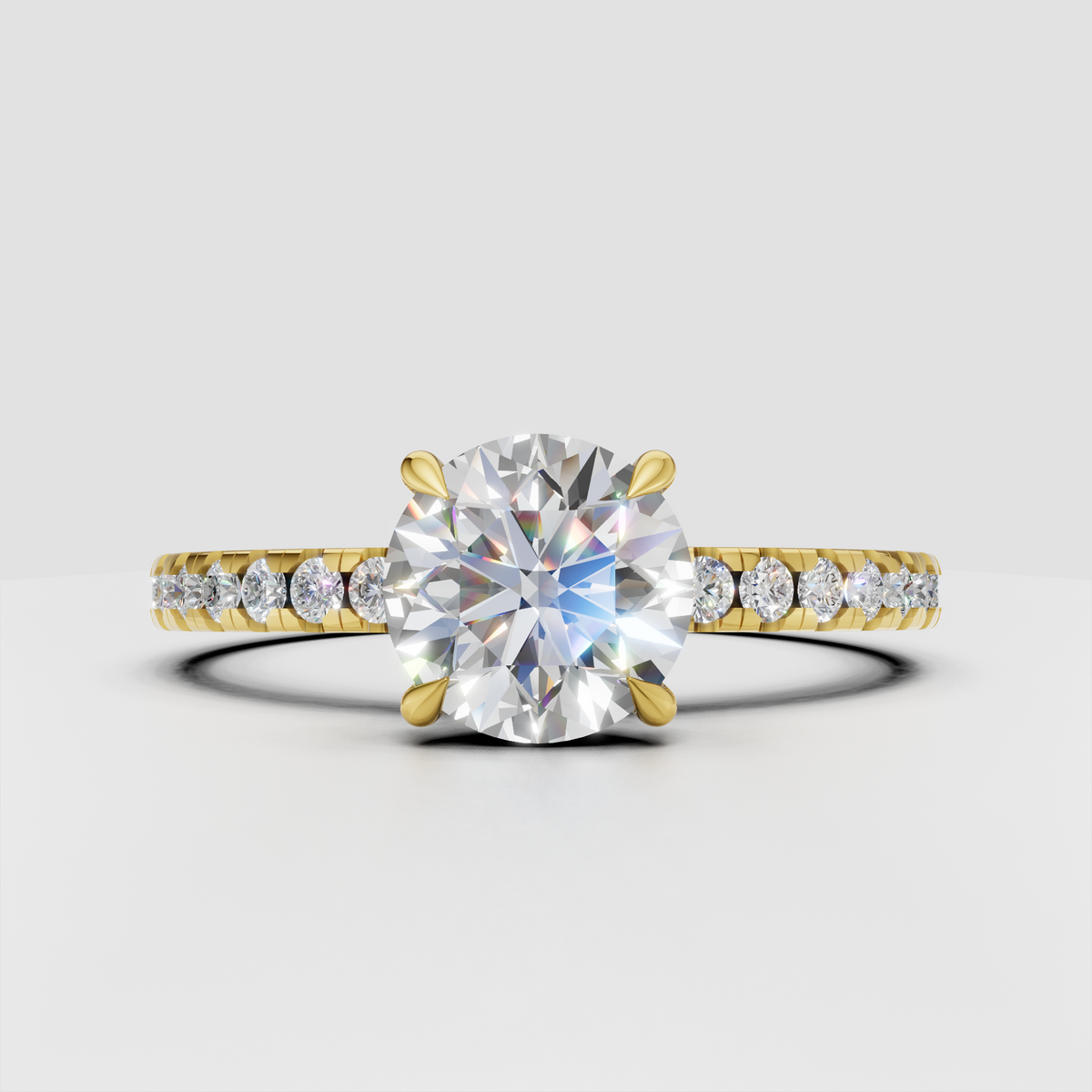 Round brilliant Diamond four-prong pavé solitaire engagement ring in polished yellow gold