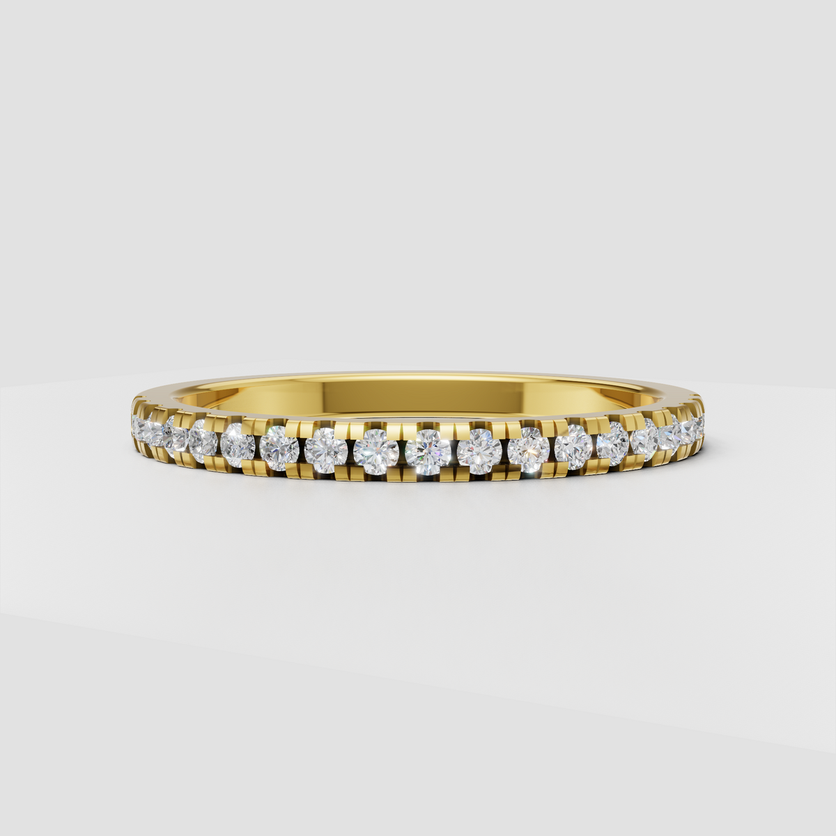 Round diamond channel setting half eternity band in polished yellow gold