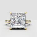 Princess cut diamond hidden halo solitaire engagement ring with pavé band in white gold.