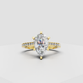 Pear-shaped diamond cathedral engagement ring with pavé band in yellow gold