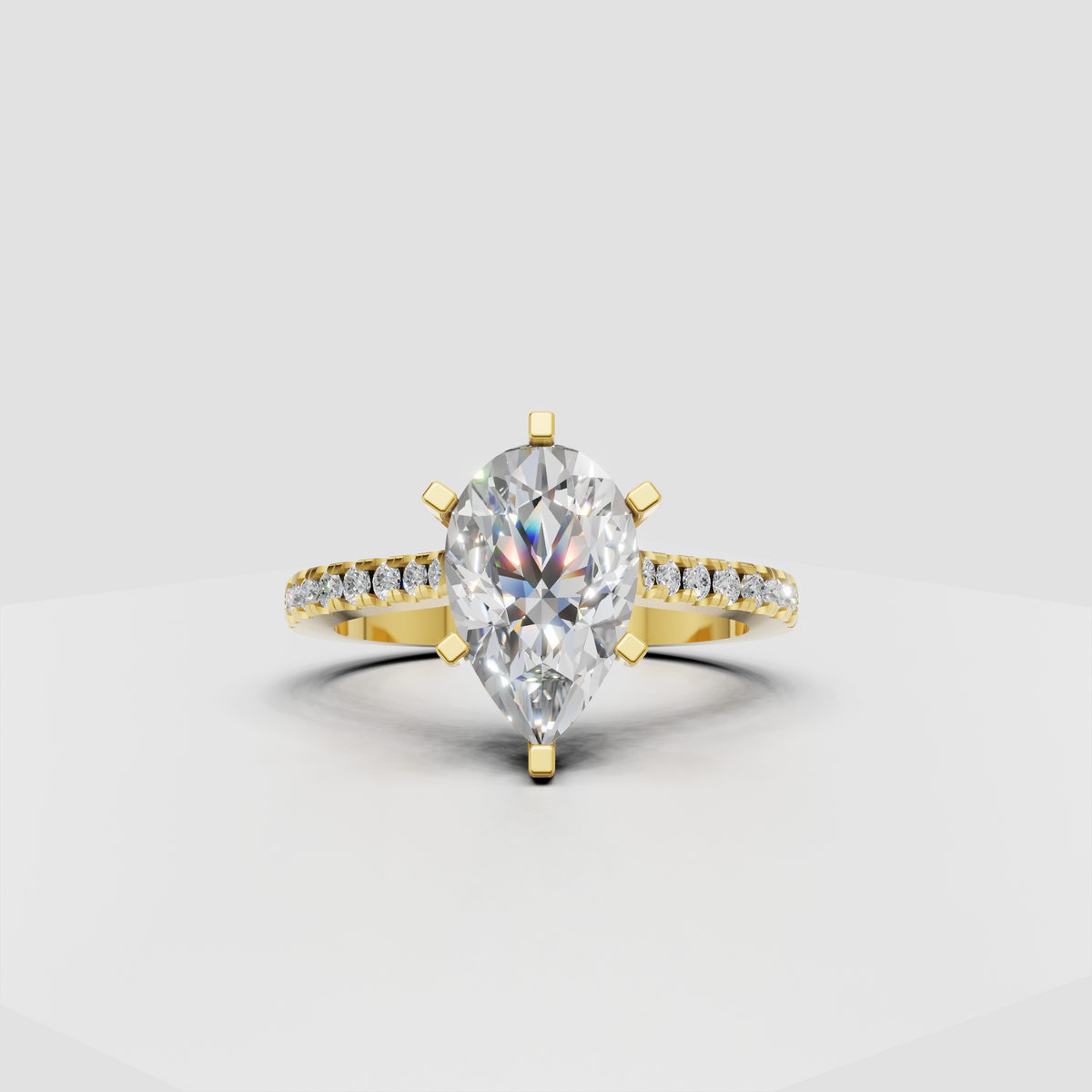 Pear-shaped diamond cathedral engagement ring with pavé band in yellow gold