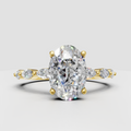 Oval diamond split shank engagement ring in polished yellow gold