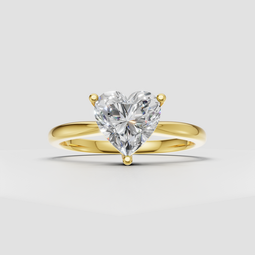 Heart cut diamond solitaire engagement ring with three prong setting and polished yellow gold band