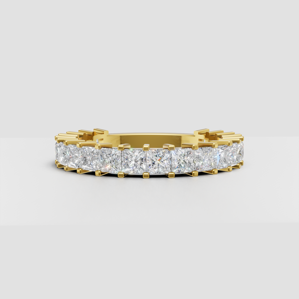 Cushion cut diamond eternity band in polished yellow gold