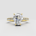 Pear diamond engagement ring with prong setting and pavé shoulders