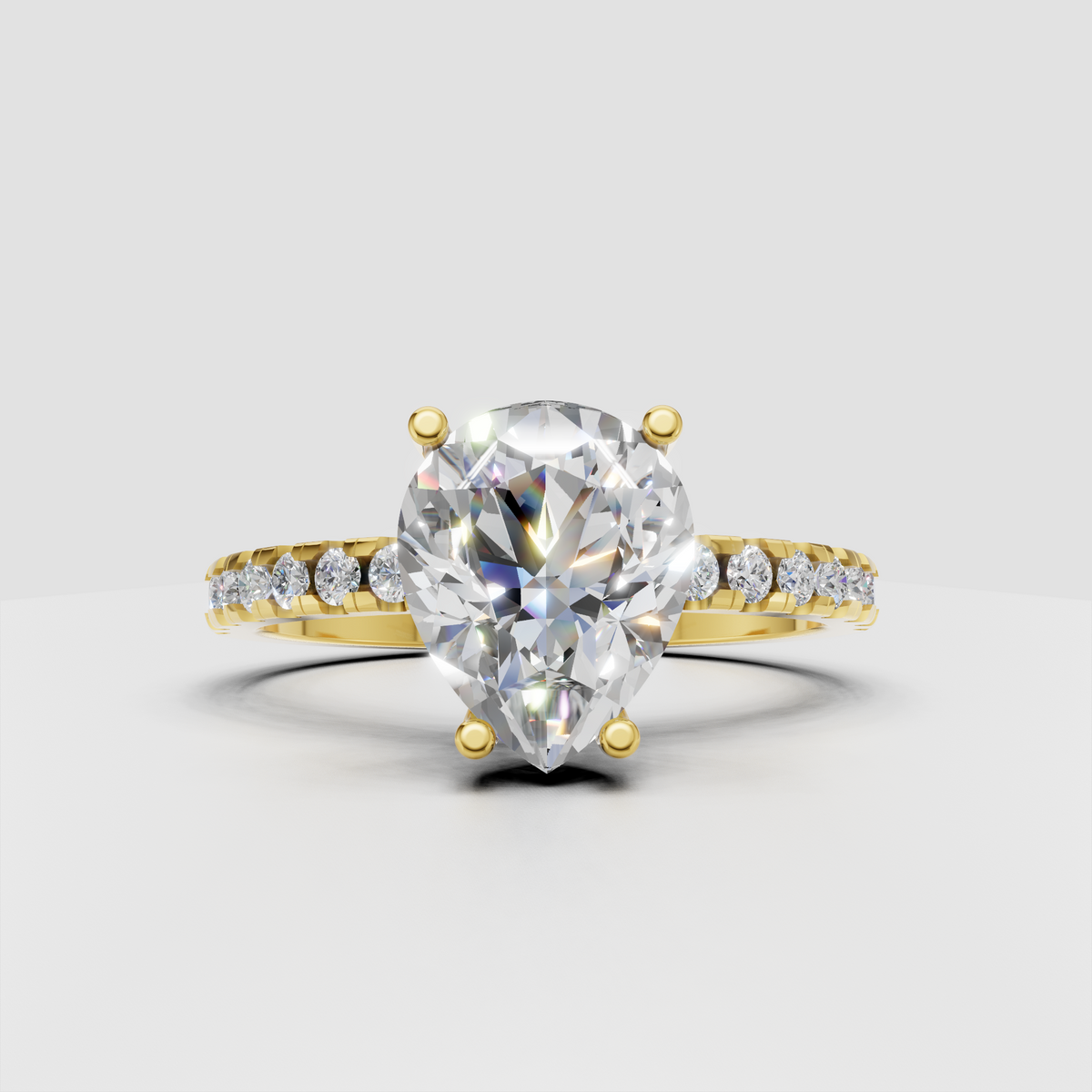 Pear diamond engagement ring with prong setting and pavé shoulders