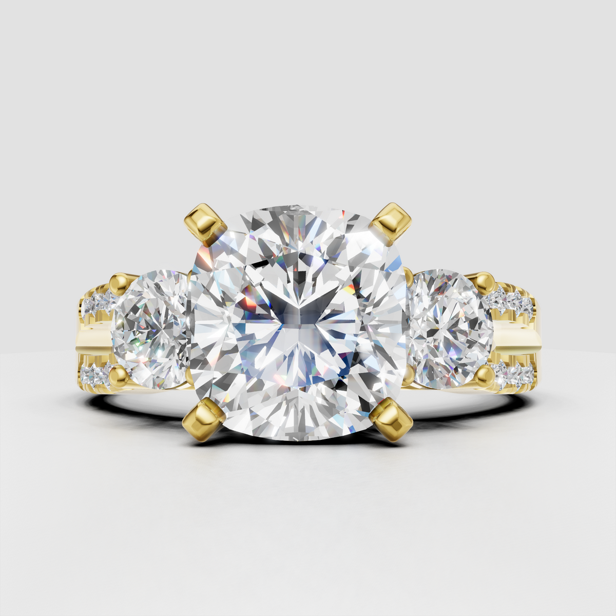 Oval diamond three stone split shank engagement ring in yellow gold