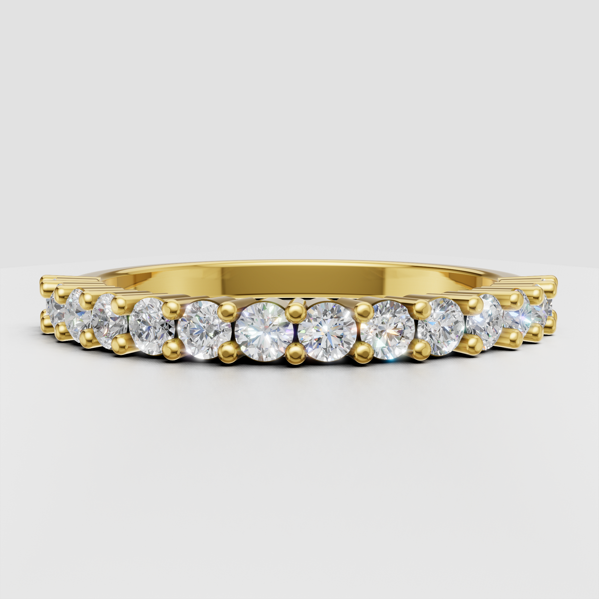 Round diamond prong-set half eternity ring in polished yellow gold