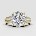 Round diamond engagement ring with split shank pavé band in polished yellow gold