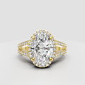 Oval diamond halo engagement ring in polished yellow gold.