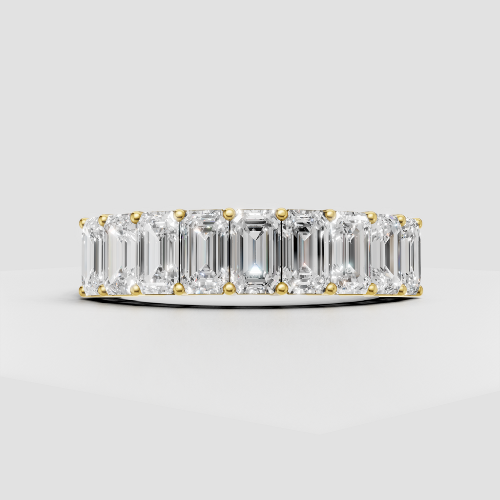 Emerald cut diamond eternity ring in polished yellow gold