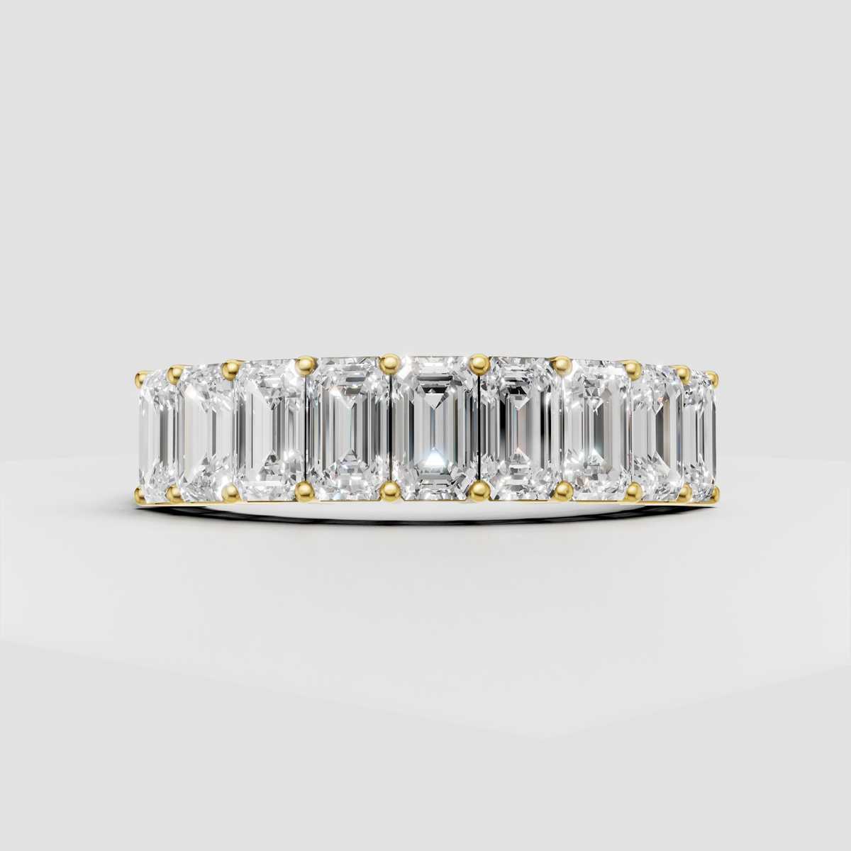 Emerald cut diamond eternity ring in polished yellow gold