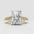 Radiant cut diamond crossover engagement ring in polished yellow gold