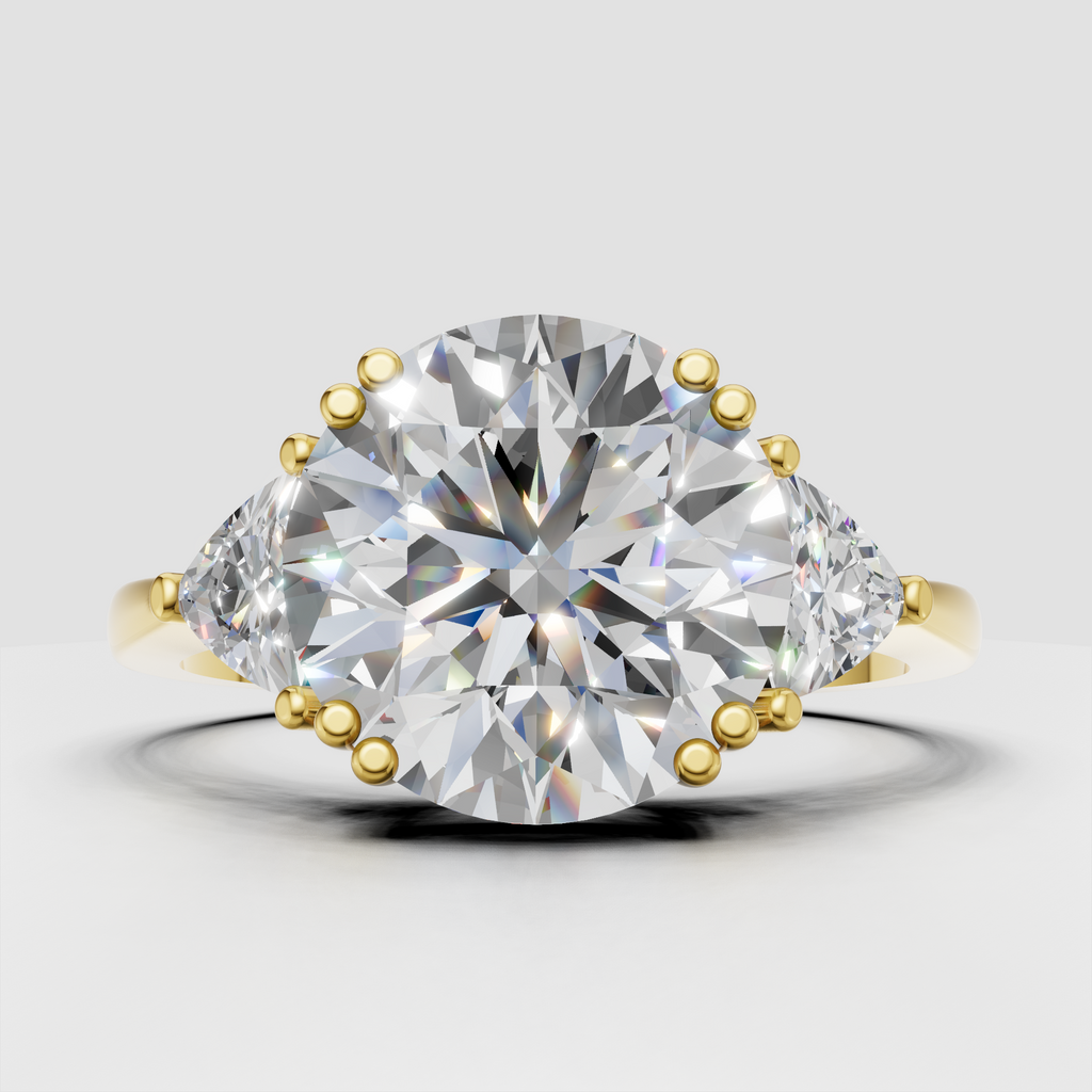 Round-cut diamond six-prong three-stone engagement ring in yellow gold