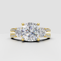 Cushion cut diamond three stone ring in yellow gold