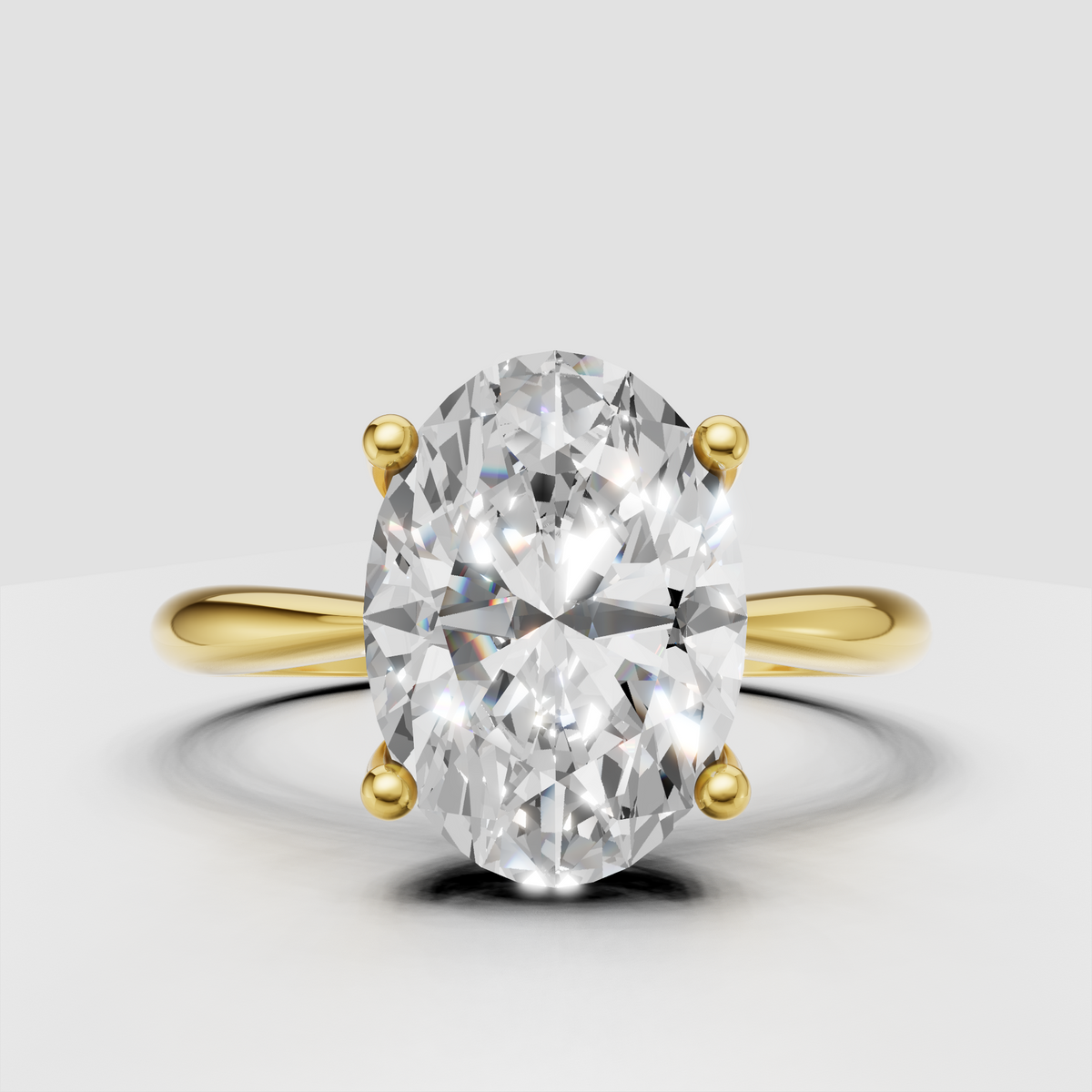 Oval brilliant Diamond four-prong solitaire engagement ring in polished yellow gold