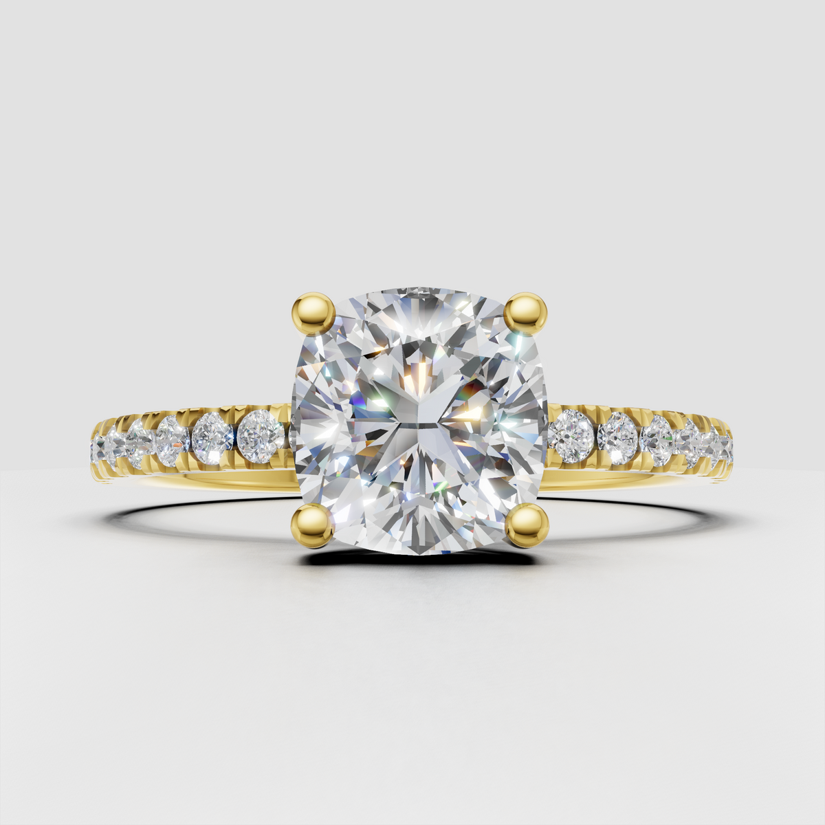 Cushion diamond cathedral pavé engagement ring in yellow gold