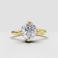 Round diamond crossover engagement ring with four-prong setting