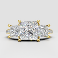 Princess cut diamond three-stone engagement ring with polished yellow gold band