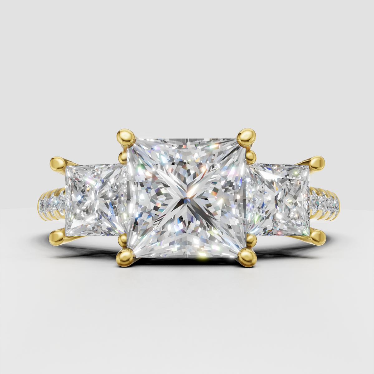 Princess cut diamond three-stone engagement ring with polished yellow gold band