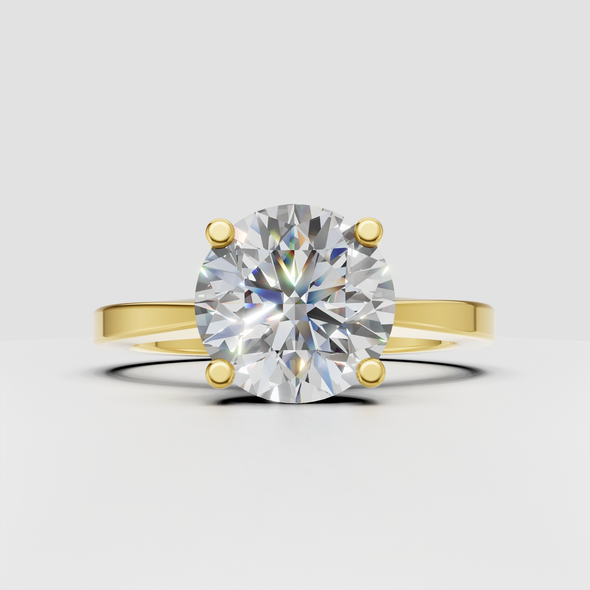 Round diamond four-prong solitaire engagement ring in polished yellow gold