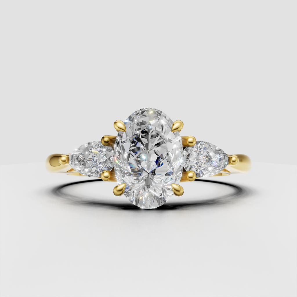 Oval diamond three-stone engagement ring in polished yellow gold