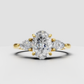 Oval diamond three-stone engagement ring in polished yellow gold