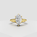 Pear-shaped diamond cathedral solitaire engagement ring in polished yellow gold