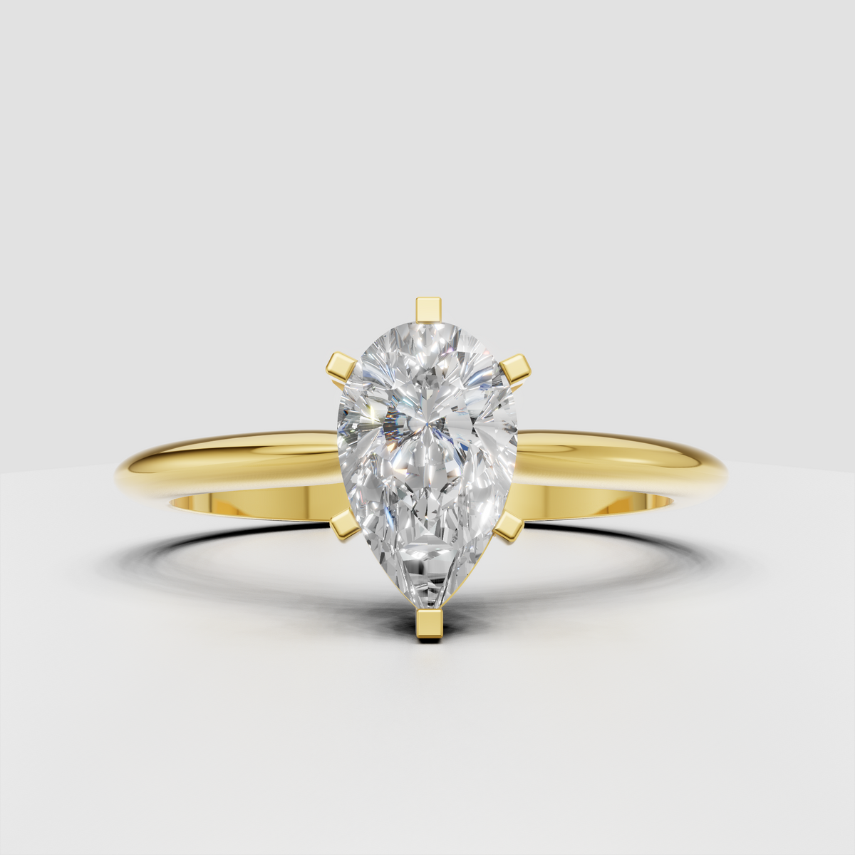 Pear diamond cathedral engagement ring with polished yellow gold band