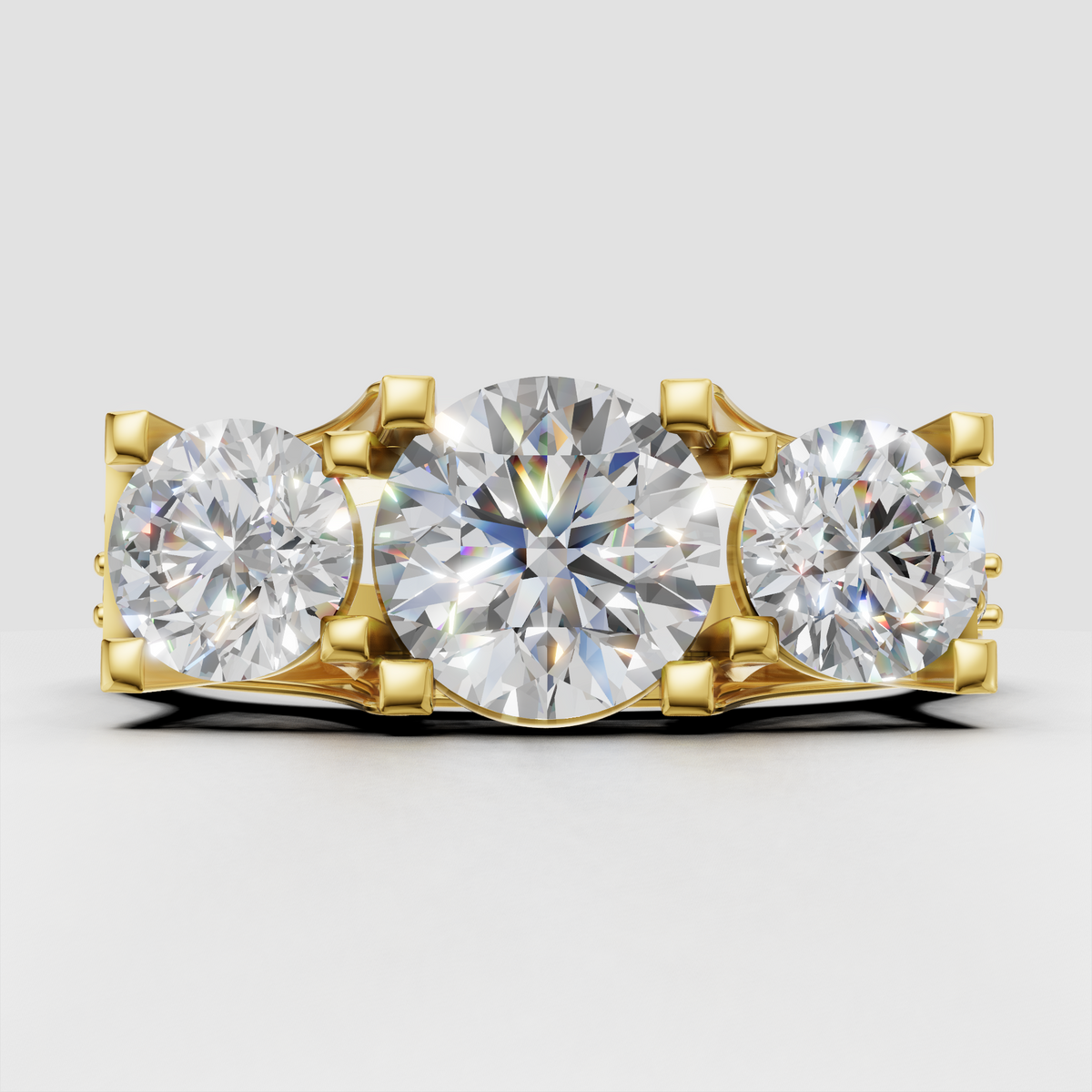 Round brilliant Diamond three-stone pavé trellis engagement ring in yellow gold