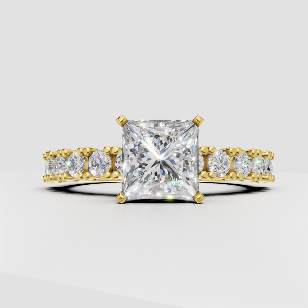 Princess cut diamond four-prong yellow gold engagement ring with pavé side stones