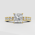 Princess cut diamond four-prong yellow gold engagement ring with pavé side stones