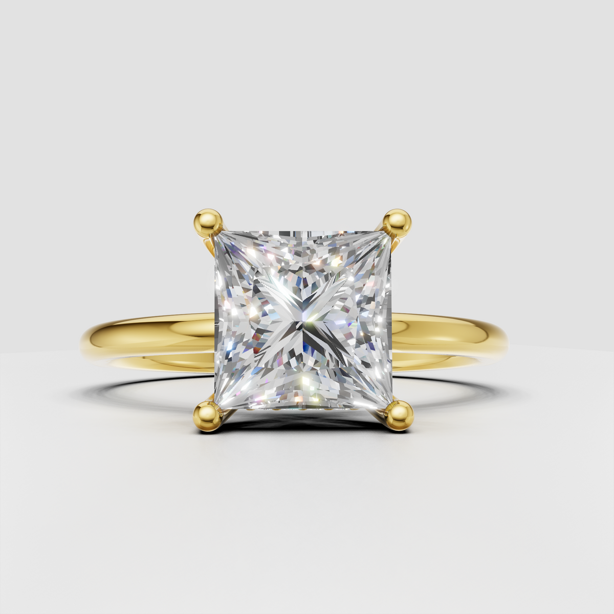 Princess cut diamond solitaire engagement ring in polished yellow gold with four-prong setting