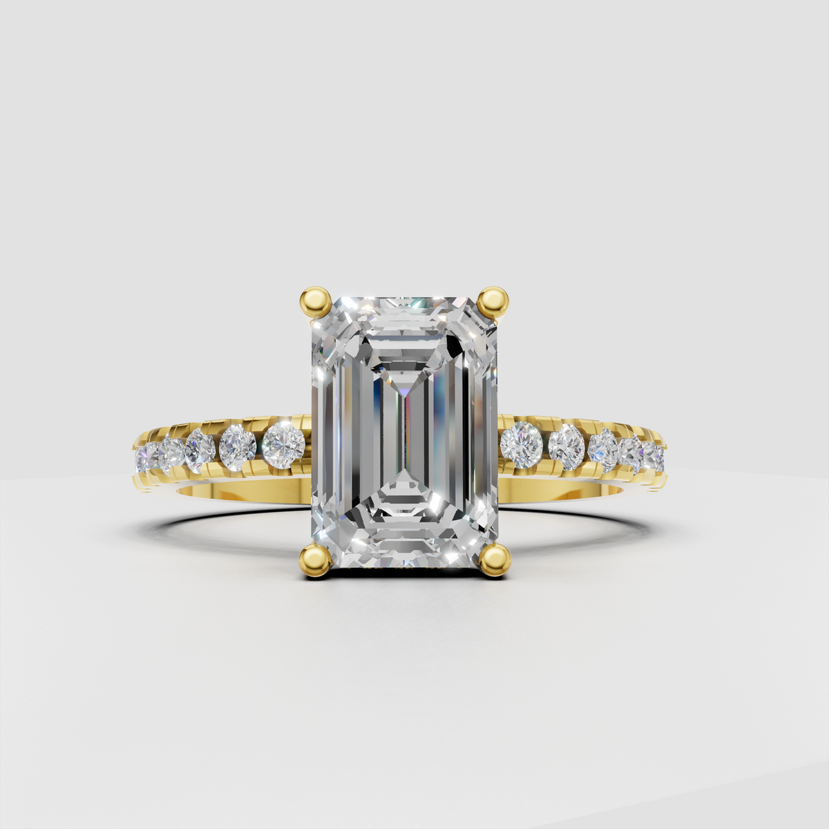 Emerald diamond four-prong pavé engagement ring in yellow gold