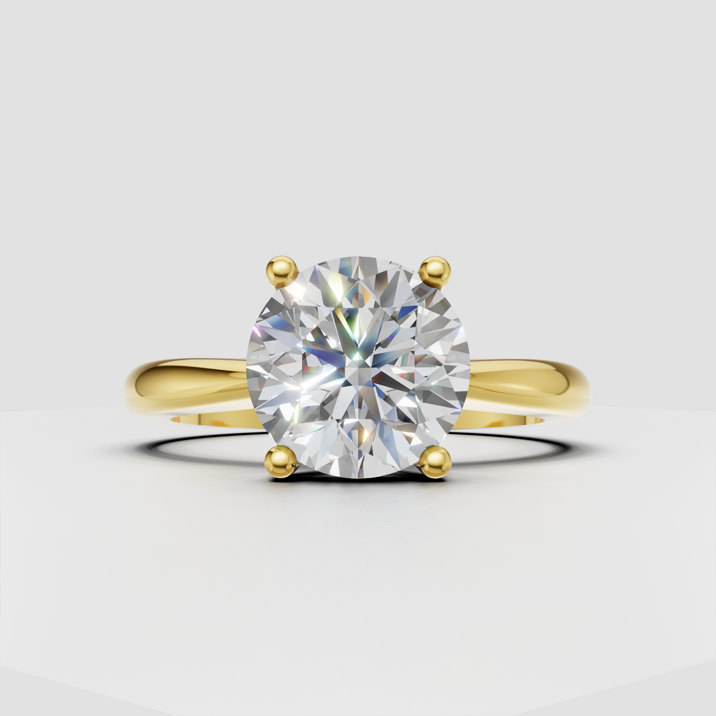 Round diamond solitaire ring in polished yellow gold with four prongs