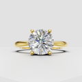 Round diamond solitaire ring in polished yellow gold with four prongs