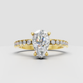 Pear diamond hidden halo pavé engagement ring in polished yellow gold