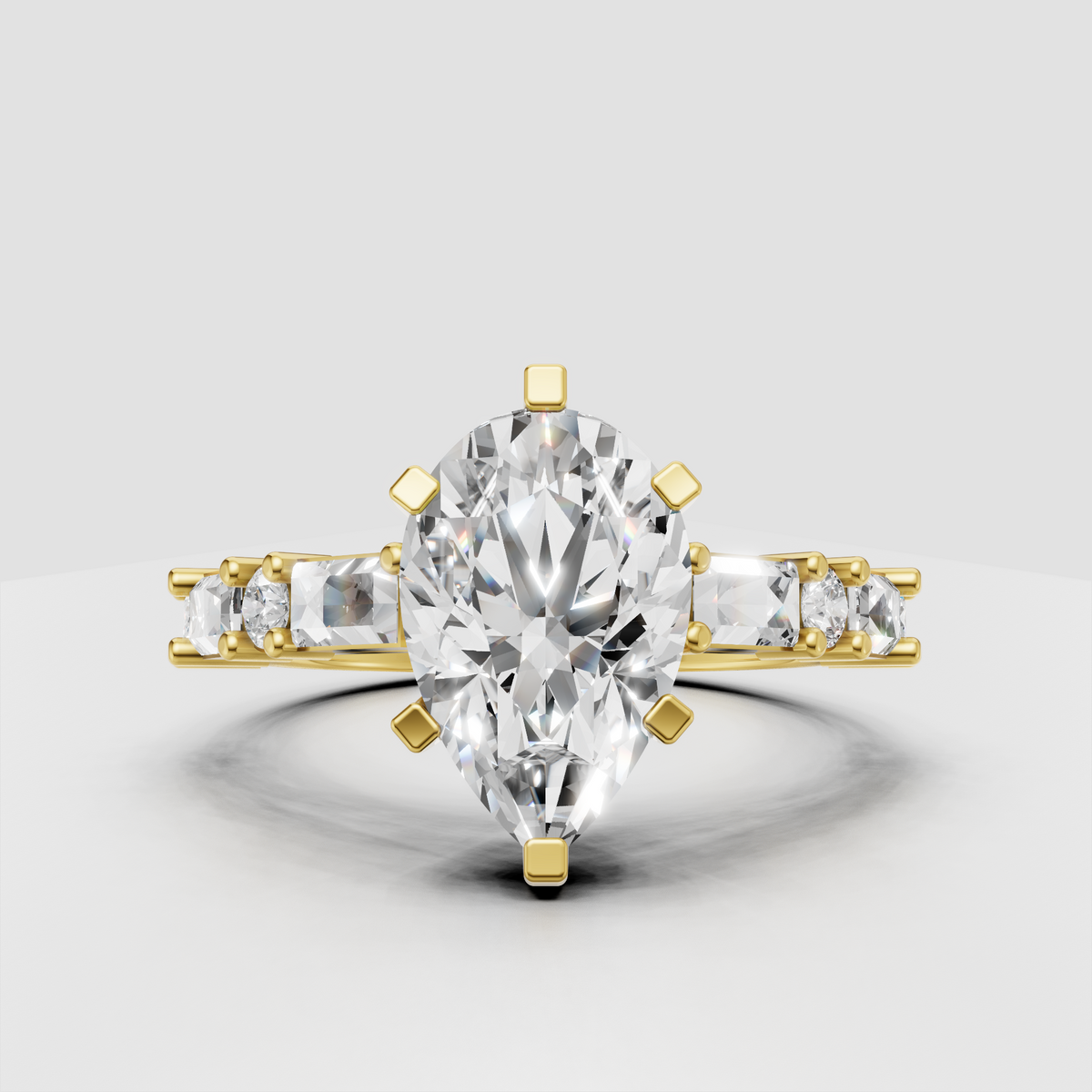 Pear cut diamond engagement ring with six-prong setting and baguette side stones