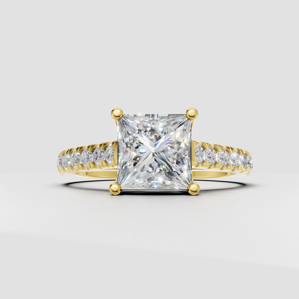 Princess cut diamond engagement ring with four prong yellow gold setting