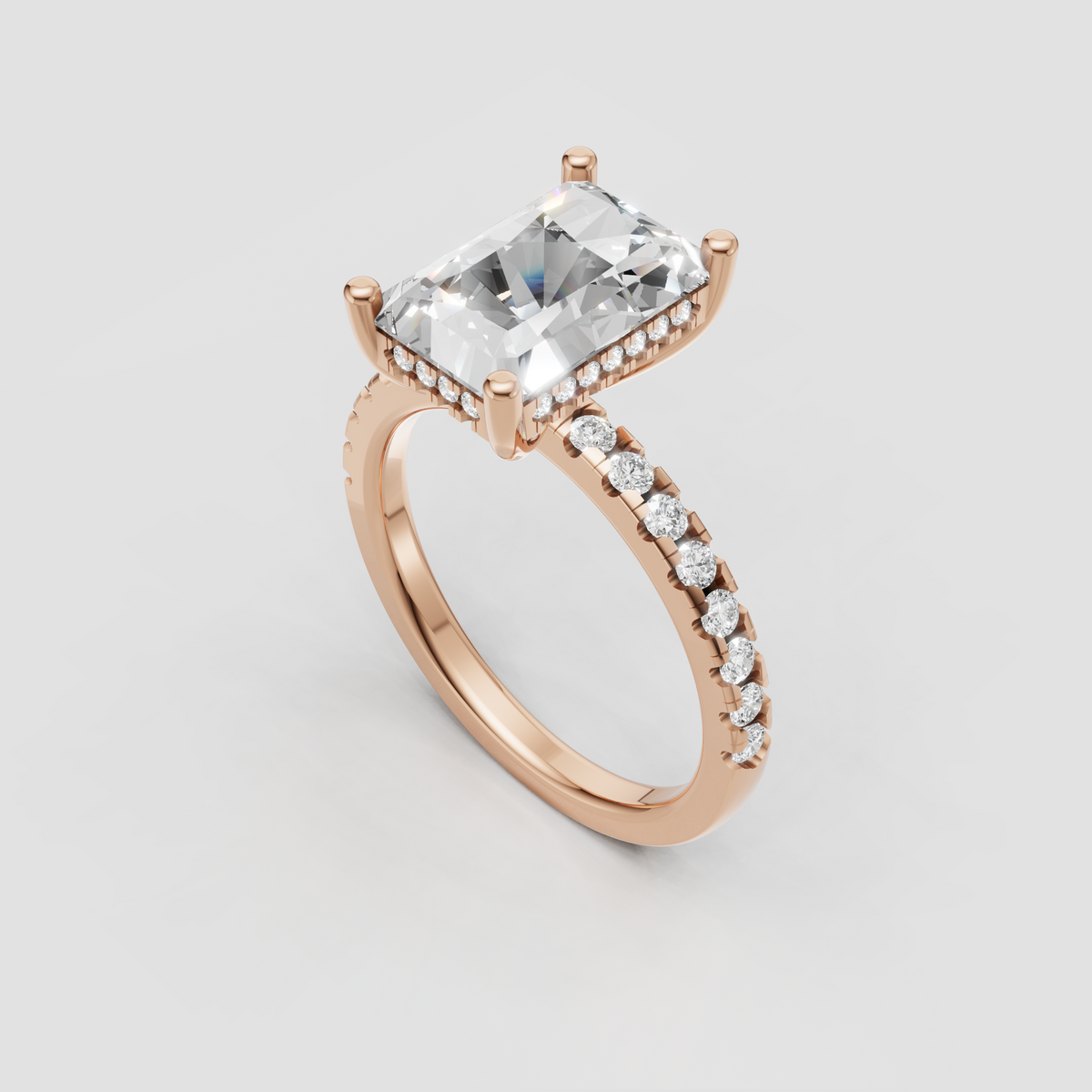 Radiant cut engagement ring with prong-set center stone and hidden halo