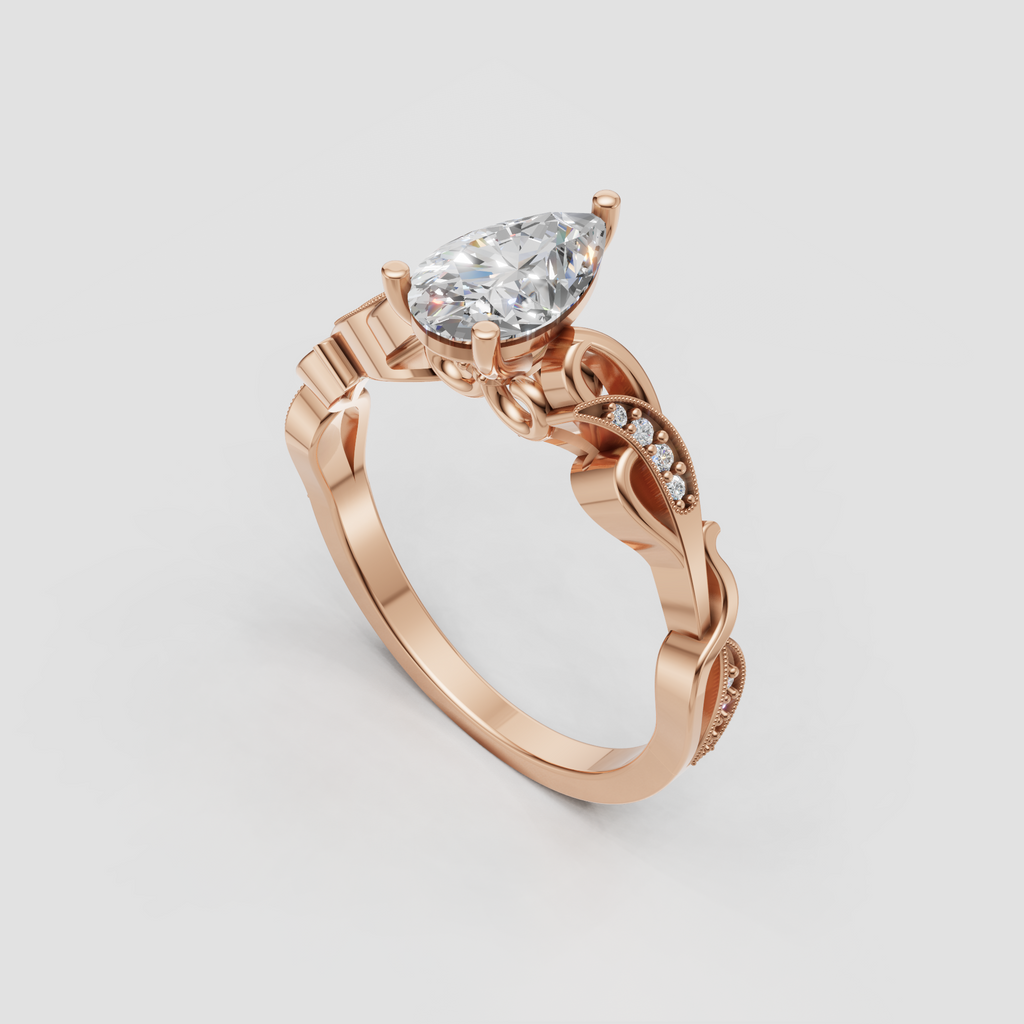 Yellow gold pear cut engagement ring with ornate side detailing