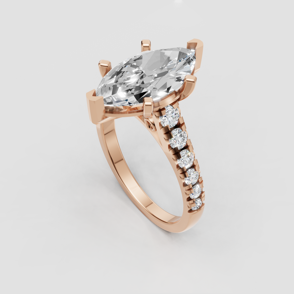 Yellow gold cathedral ring featuring marquise cut diamond and sparkling pavé shoulders